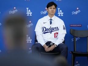 Los Angeles Dodgers' Shohei Ohtani listens to questions during a baseball news conference at Dodger Stadium Thursday, Dec. 14, 2023, in Los Angeles.