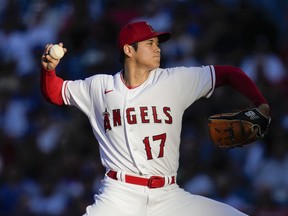 FILE - Los Angeles Angels starting pitcher Shohei Ohtani throws during a baseball game against the Los Angeles Dodgers in Anaheim, Calif., June 21, 2023. Ohtani agreed Saturday, Dec. 9, to a record $700 million, 10-year contract with the Dodgers.