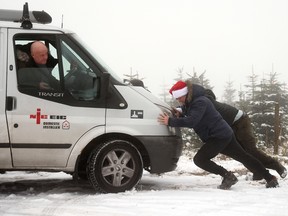 A van is pushed out of snow