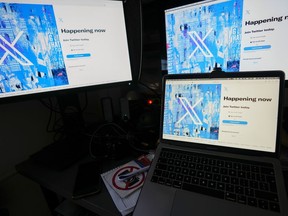 Computer monitors and a laptop display the X, formerly known as Twitter, sign-in page, July 24, 2023, in Belgrade, Serbia.