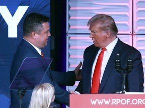 Republican Party of Florida chairman Christian Ziegler, left, greets former president Donald Trump at the RPOF Freedom Summit in Kissimmee, Fla., Nov. 4, 2023. Ziegler is the subject of a rape investigation, though no charges have been filed.