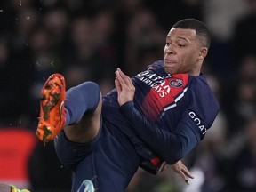 PSG's Kylian Mbappe tries a shot during the French League One soccer match between Paris Saint-Germain and Nantes at the Parc des Princes in Paris, Saturday, Dec. 9, 2023.