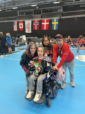 Gavi Engel-Yan, 13, with mom Ali (L), dad Joshua (R), and caregiver Rose Salas (C), at the World Cup of Volt Hockey.