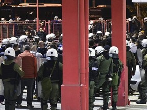 Riot police detain dozens of fans