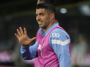 FILE - Uruguay's Luis Suarez waves from the bench during a qualifying soccer match for the FIFA World Cup 2026 against Argentina at La Bombonera stadium in Buenos Aires, Argentina, Nov. 16, 2023. The 37-year-old Suárez scored 17 goals for Brazilian league runner-up Gremio, Wednesday, Dec. 6, 2023.