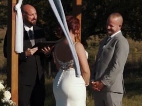Screengrab of bride, groom and officiant at outdoor wedding