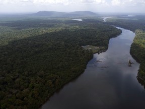 The Essequibo River flows through Kurupukari crossing in Guyana, Saturday, Nov. 19, 2023. Venezuela has long claimed Guyana's Essequibo region, a territory larger than Greece and rich in oil and minerals.