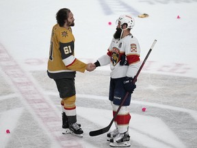 Vegas Golden Knights Mark Stone (61), left, and Florida Panthers Radko Gudas (7) shake hands after Vegas won the Stanley Cup in Game 5 of the NHL hockey Stanley Cup Finals Tuesday, June 13, 2023, in Las Vegas. The governing body for amateur hockey in Newfoundland and Labrador has banned end-of-game handshakes. A post today on Hockey NL's website says there have been "issues" with the handshakes "that have led to suspensions for players and coaches."