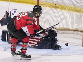 Canada's Marie-Philip Poulin scores on American goaltender Nicole Hensley during the shootout at the Canada USA Rivalry Series game in Sarnia, Ont., Saturday, Dec. 16, 2023.