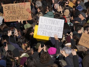 Women show banners reading " You are healthy children of patriarchy" and "femicide is a state murder, the state does not protect us" as they gather on the occasion of International Day for the Elimination of Violence against Women, in Milan, Italy, Saturday, Nov. 25, 2023.