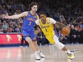 Los Angeles Lakers guard D'Angelo Russell (1) drives against Oklahoma City Thunder guard Josh Giddey (3) during the first half of an NBA basketball game Thursday, Nov. 30, 2023, in Oklahoma City.