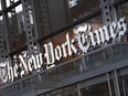 FILE - A sign for The New York Times hangs above the entrance to its building, Thursday, May 6, 2021 in New York. The New York Times filed a federal lawsuit against OpenAI and Microsoft on Wednesday, Dec. 27, 2023 seeking to end the practice of using published material to train chatbots.