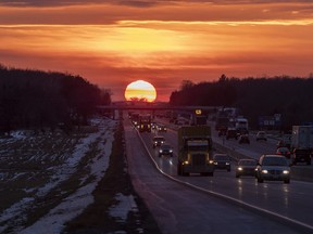 The sun sets as traffic moves along Highway 401 in Belleville, Ont., on Tuesday, December 21, 2021. Ontario is considering introducing an enhanced road test for drivers over 80 years old, and is looking at how to better deter stunt driving.