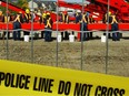 A group of forensic experts searches through dirt on conveyer belts in Port Coquitlam at the pig farm owned by William Pickton where some of the missing women from Vancouver have been found. Photo: Jeff Vinnick