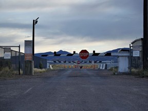 According to a new poll, 79 per cent of Canadians and 84 per cent of Americans reported believing in at least one conspiracy theory. Signs warn about trespassing at an entrance to the Nevada Test and Training Range near Area 51 outside of Rachel, Nev.,&ampnbsp;July 22, 2019.&ampnbsp;THE CANADIAN PRESS/AP-John Locher