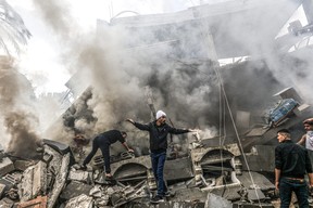 Palestinians react amid the rubble of destroyed buildings following an Israeli bombardment on Dec. 14, 2023 in Rafah, in the southern Gaza Strip, amid ongoing battles between Israel and the Palestinian militant group Hamas.