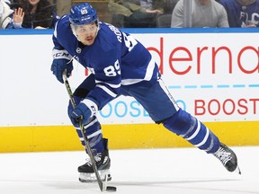Nick Robertson of the Maple Leafs skates with the puck
