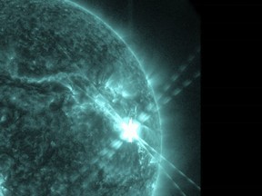 This photo provided by NASA's Solar Dynamics Observatory captured this image of a solar flare, as seen in the bright flash in the upper right, on Thursday, Dec. 14, 2023.