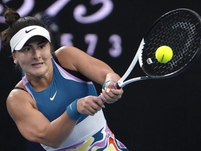 Bianca Andreescu of Canada plays a backhand return to Cristina Bucsa of Spain during their second round match at the Australian Open tennis championship in Melbourne, Australia, Wednesday, Jan. 18, 2023. Andreescu says she won't play in next month's Australian Open because of a nagging back injury.