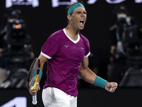 FILE - Rafael Nadal of Spain reacts after winning the third set against Daniil Medvedev of Russia during the men's singles final at the Australian Open tennis championships in Melbourne, Australia, Sunday, Jan. 30, 2022. Rafael Nadal says that he will return to playing at the Brisbane International in Australia in January.
