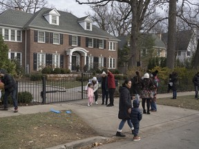 People visit the house featured in the movie "Home Alone" in Winnetka, Ill., on Nov. 27, 2021. MUST CREDIT: Youngrae Kim for The Washington Post