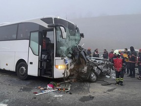 Officials investigate at the site of seven vehicles crash, in Sakarya Turkey, Thursday, Dec. 28, 2023.