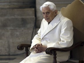 FILE - Pope Emeritus Benedict XVI sits in St. Peter's Basilica as he attends the ceremony marking the start of the Holy Year, at the Vatican, Dec. 8, 2015. The Vatican next year will publish a collection of private homilies delivered by the late Pope Benedict XVI for his Sunday Masses, most of them penned during his 10-year retirement, officials said Saturday, Dec. 23, 2023.