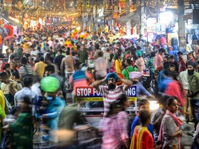 people walk in a market in Jalandhar