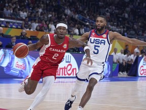 Canada guard Shai Gilgeous-Alexander (2) drives past U.S. forward Mikal Bridges (5) during the Basketball World Cup bronze medal game between the United States and Canada in Manila, Philippines, Sunday, Sept. 10, 2023. A corner was turned on the heels of disappointment for Canada Basketball.