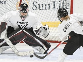 Montreal's Kristin O'Neill moves in on goaltender Ann-Renee Desbiens during the Professional Women's Hockey League's (PWHL) training camp in Montreal on Saturday, Nov. 18, 2023.