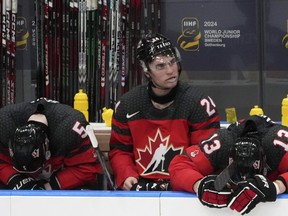 Canada players (left to right) Oliver Bonk (5), Denton Mateychuk (24) and Maveric Lamoureux (13) react following their loss to Czechia.