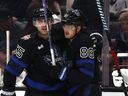 William Nylander of the Toronto Maple Leafs celebrates his empty-net goal with Mark Giordano to take a 3-0 lead against the Los Angeles Kings.