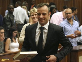 Oscar Pistorius, centre, leaves a courtroom of the High Court in Pretoria, South Africa, in 2015.