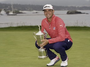 Gary Woodland poses with the trophy after winning the U.S. Open golf tournament in 2019.