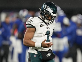 Philadelphia Eagles quarterback Jalen Hurts walks off the field with a finger injury against the New York Giants.