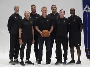 Golden State Warriors head coach Steve Kerr, centre, poses for photos with assistants Bruce Fraser, clockwise from top left, Chris DeMarco, Dejan Milojevic, Kris Weems, Kenny Atkinson and Ron Adams.