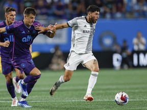 Toronto FC midfielder Jonathan Osorio, right, beats Charlotte FC midfielder Andrew Privett to the ball during a game in 2023.