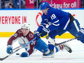 Colorado Avalanche centre Ross Colton (20) vies for control of the puck with Toronto Maple Leafs centre Calle Jarnkrok.