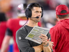 Ex-Tampa Bay Buccaneers offensive coordinator Dave Canales holds the play sheet on the sidelines.
