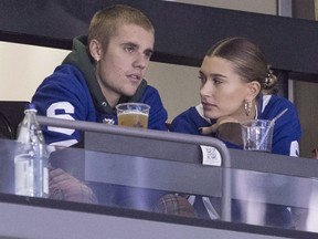 Justin Bieber watches a Toronto Maple Leafs game alongside his wife Hailey.