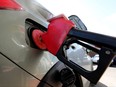 A vehicle is being filled with gas at a gas station in Edmonton on April 1, 2022.