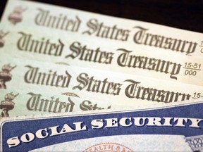 In this photo illustration, a Social Security card sits alongside checks from the U.S. Treasury on Oct. 14, 2021 in Washington, D.C.