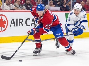 Lightning's Alex Barré-Boulet uses his stick to try to slow down Canadiens' Christian Dvorak during game last November at the Bell Centre.