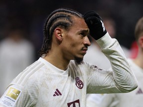 Bayern Munich's German forward #10 Leroy Sane (L) reacts after the German first division Bundesliga football match between Eintracht Frankfurt and FC Bayern Munich in Frankfurt, western Germany on December 9, 2023. (Photo by DANIEL ROLAND/AFP via Getty Images)
