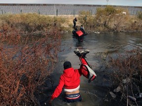 Migrants cross the Rio Bravo