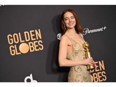 Emma Stone poses with the award for Best Performance by a Female Actor in a Motion Picture - Musical or Comedy for "Poor Things" in the press room during the 81st annual Golden Globe Awards at The Beverly Hilton hotel in Beverly Hills, Calif., on Jan. 7, 2024.