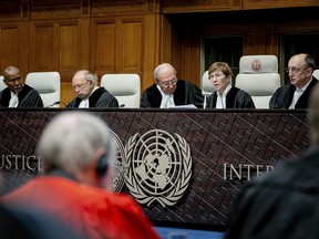 President of the International Court of Justice (ICJ) US lawyer Joan Donoghue (2R) confers with colleagues at the court in The Hague on January 12, 2024. (Photo by REMKO DE WAAL/ANP/AFP via Getty Images)