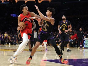 Scottie Barnes #4 of the Toronto Raptors dribbles into the defense of Max Christie #10 of the Los Angeles Lakers during the second half of a game at Crypto.com Arena on January 09, 2024 in Los Angeles. (Photo by Sean M. Haffey/Getty Images)