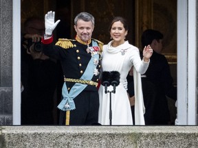 King Frederik X and Queen Mary of Denmark wave.