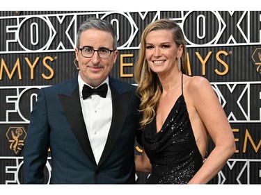 John Oliver and wife Kate Norley arrive for the 75th Emmy Awards at the Peacock Theatre at L.A. Live in Los Angeles on Jan. 15, 2024.